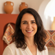 Portrait of a smiling Spanish woman, representing a happy and trusted customer.